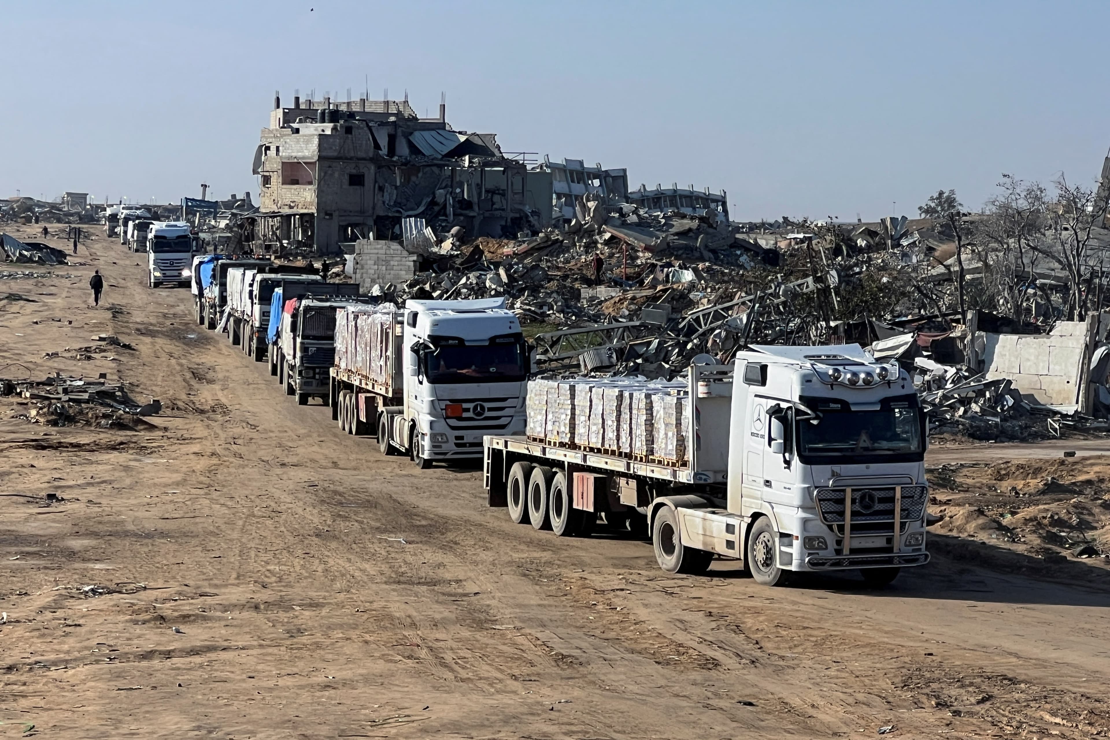 Israel to halve aid trucks to Gaza, citing Hamas ceasefire violations