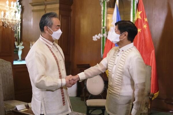 Marcos plays balancing act in meeting with China's FM | AP News